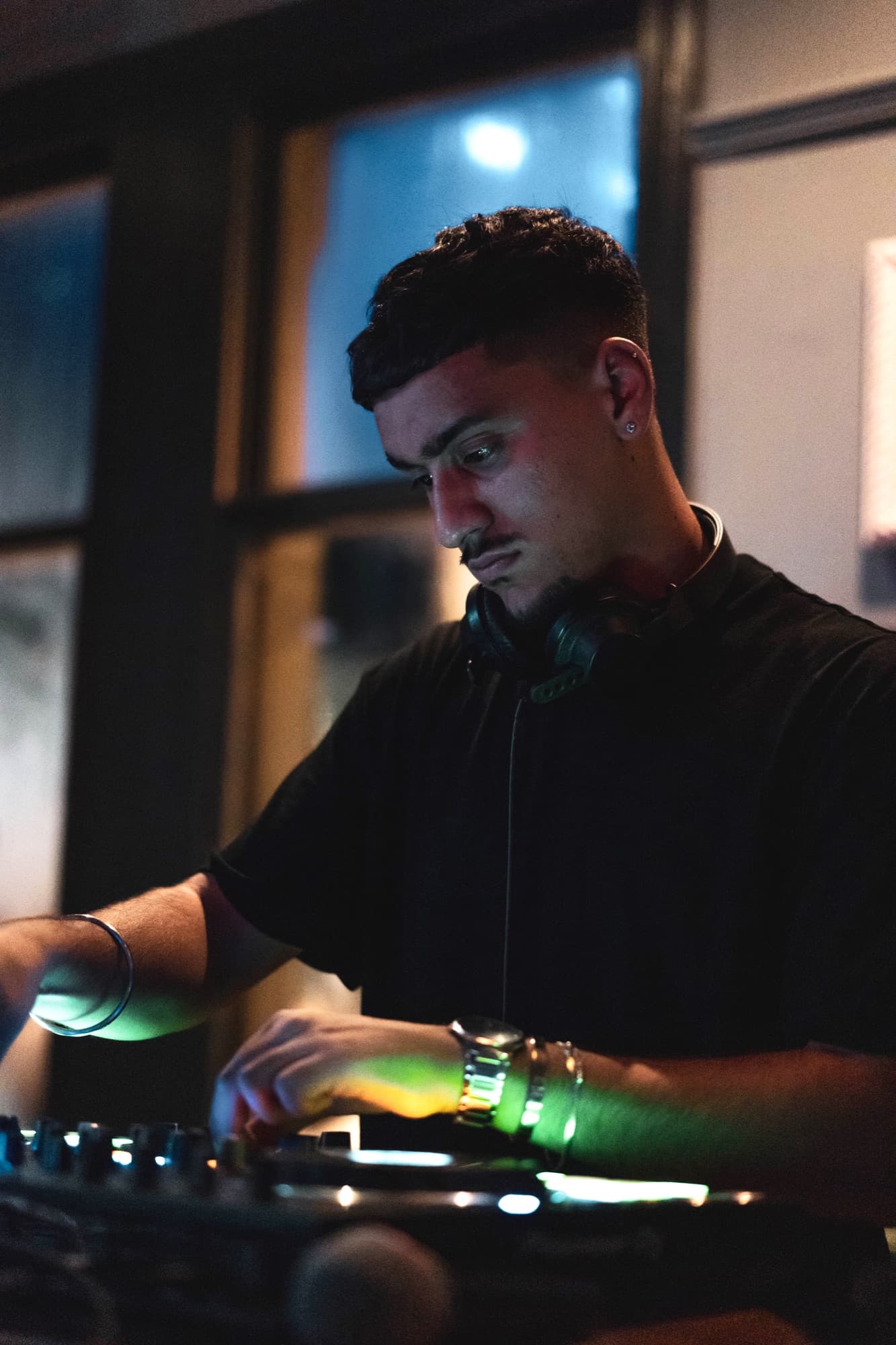 DJ AJ focused on the decks during a live set