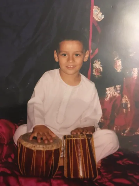 AJ as a young child playing tabla