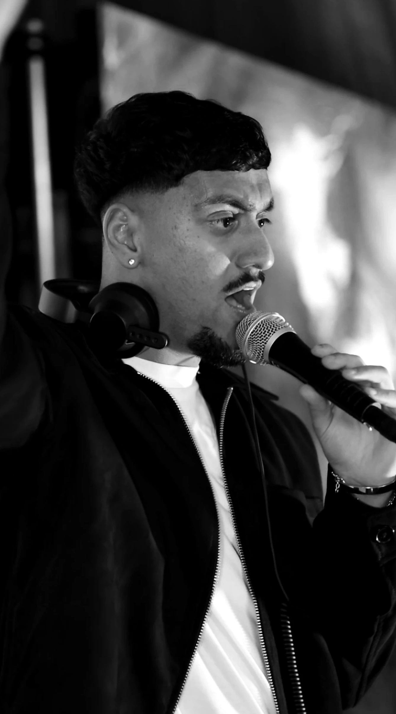 DJ AJ hosting a live celebration with a microphone