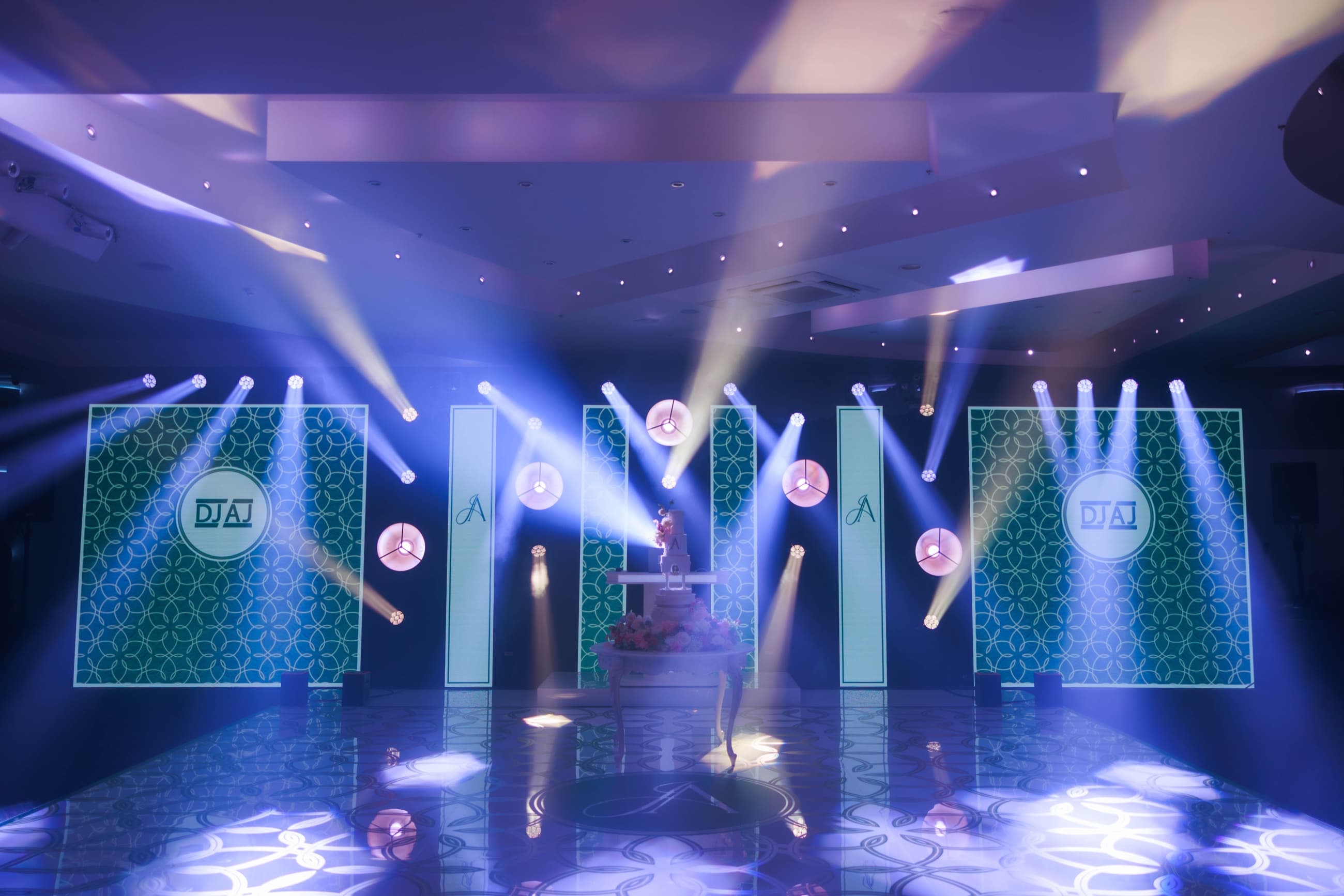 Grand Experience wedding production with LED screens, custom graphics, lighting and a monogrammed dance floor